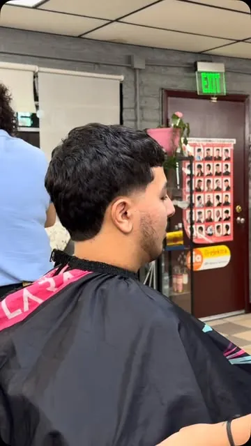 Side profile of a young man with a low taper fade and textured top